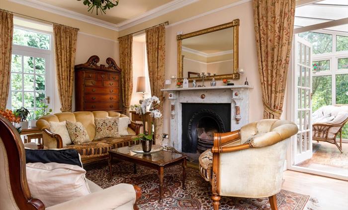 Afon Rhaiadr Country House is a 5-star Victorian B&B in Snowdonia, set in nature. Relax with a drink in the stylish sitting room by a cozy wood fire.